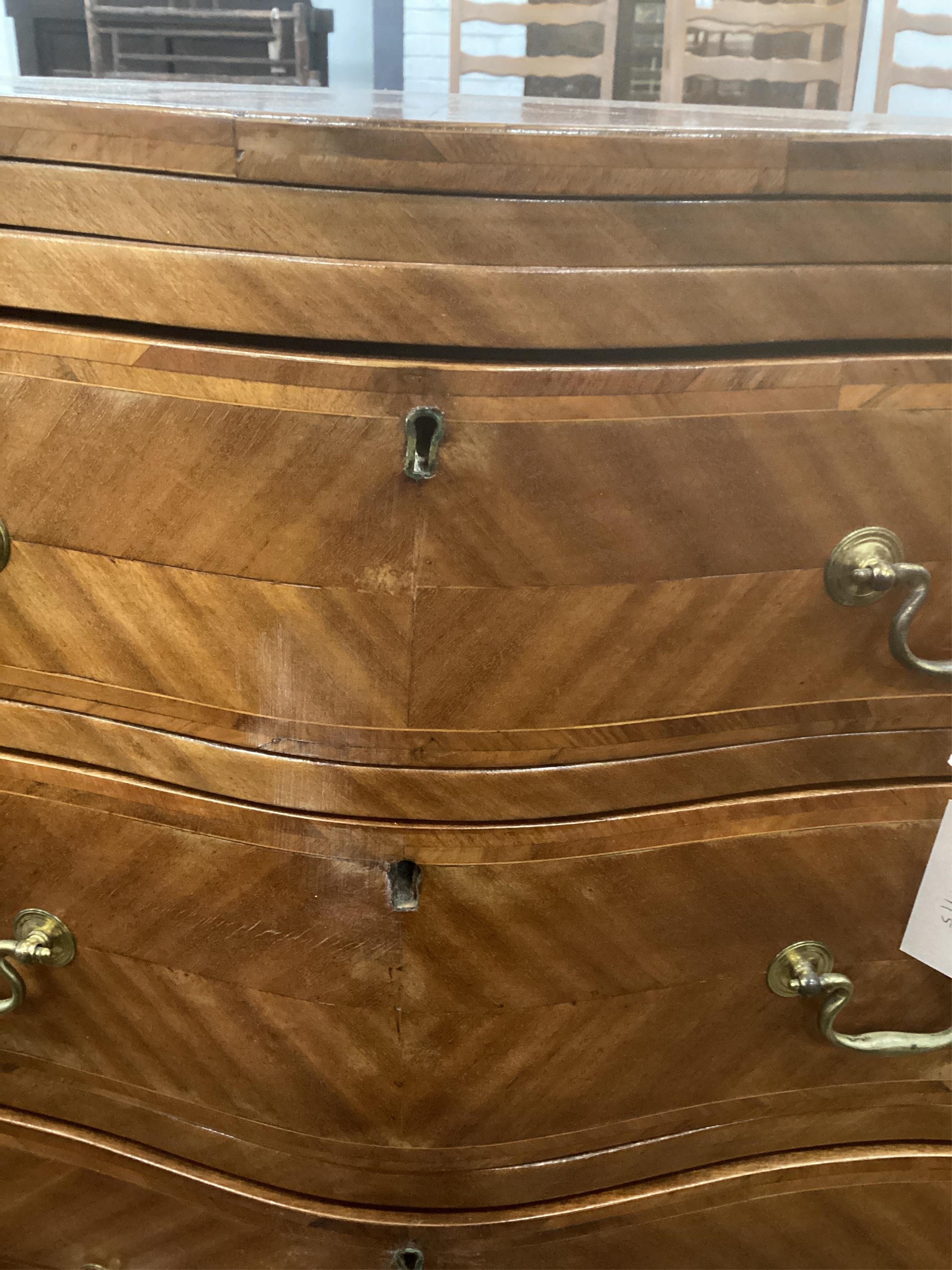 A small reproduction mahogany serpentine chest, with slide, width 60cm, depth 39cm, height 71cm. Condition - fair